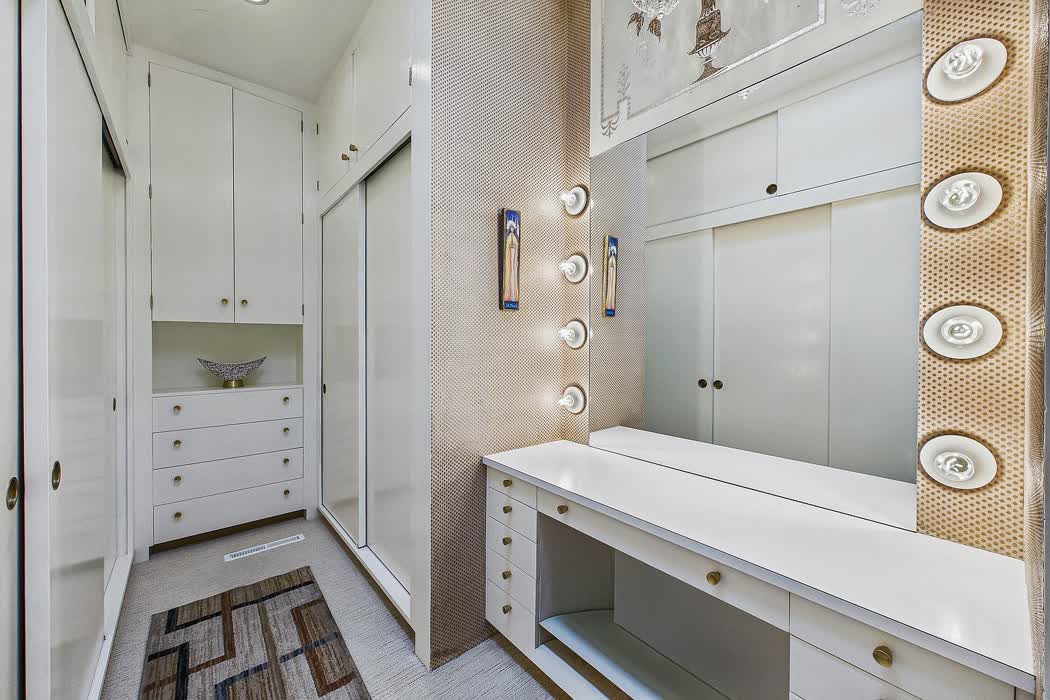 A dressing-room vanity ringed with round bulb lights, like a theatrical make-up mirror.